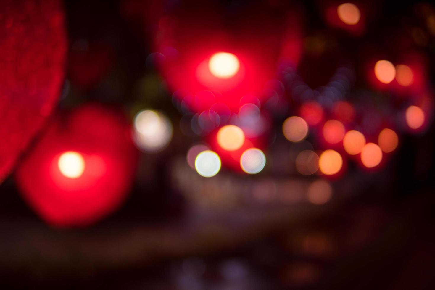 City night light blur bokeh , defocused red heart light background. photo