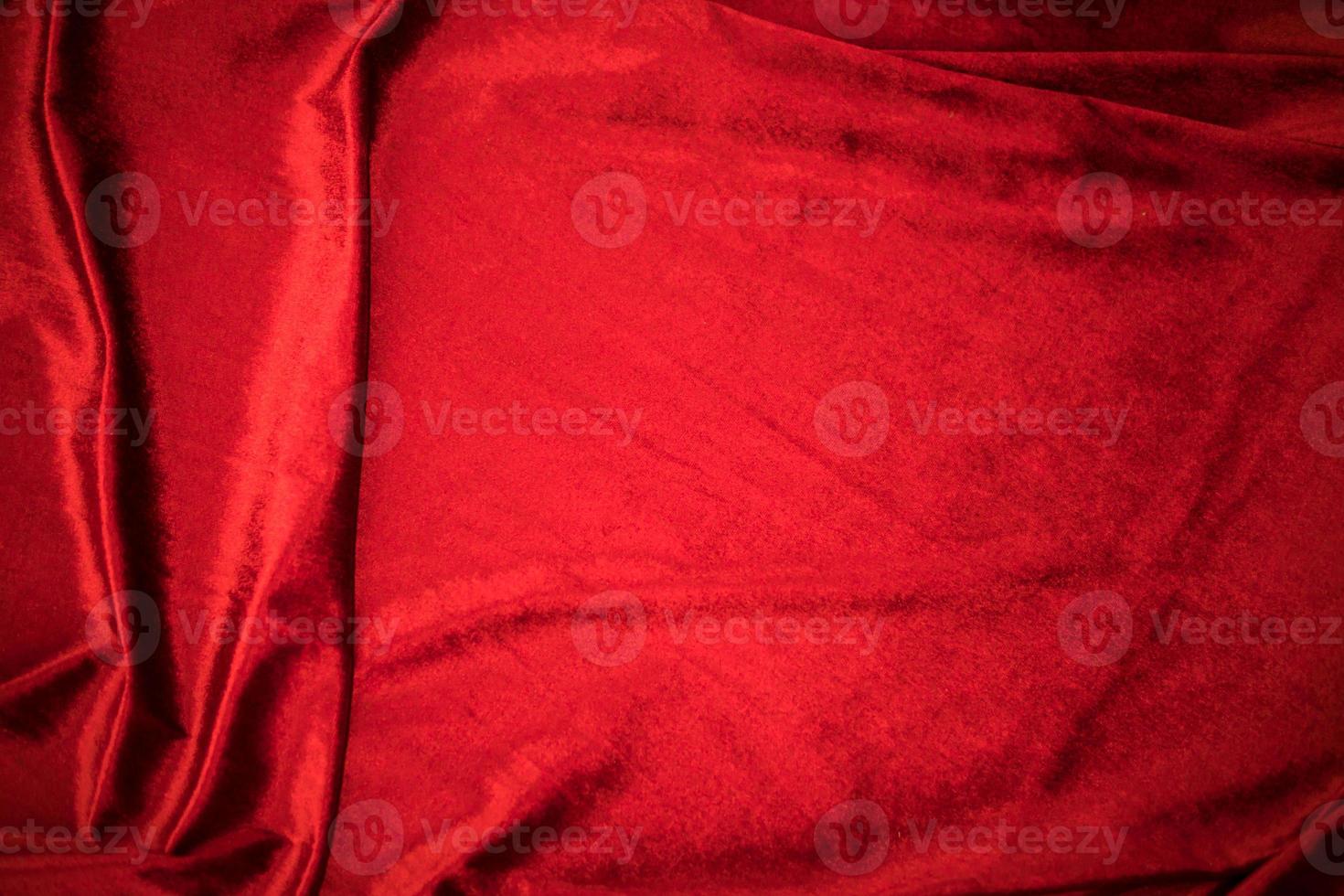 Fold soft waved red velour fabric textured background. photo