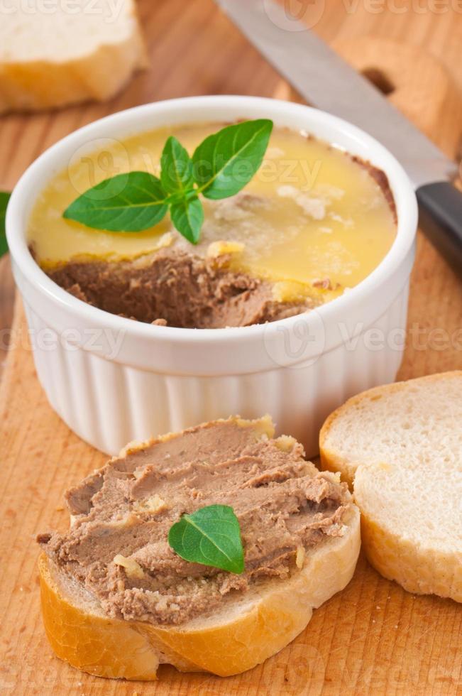 Homemade chicken liver pate, basil and slices of white bread photo