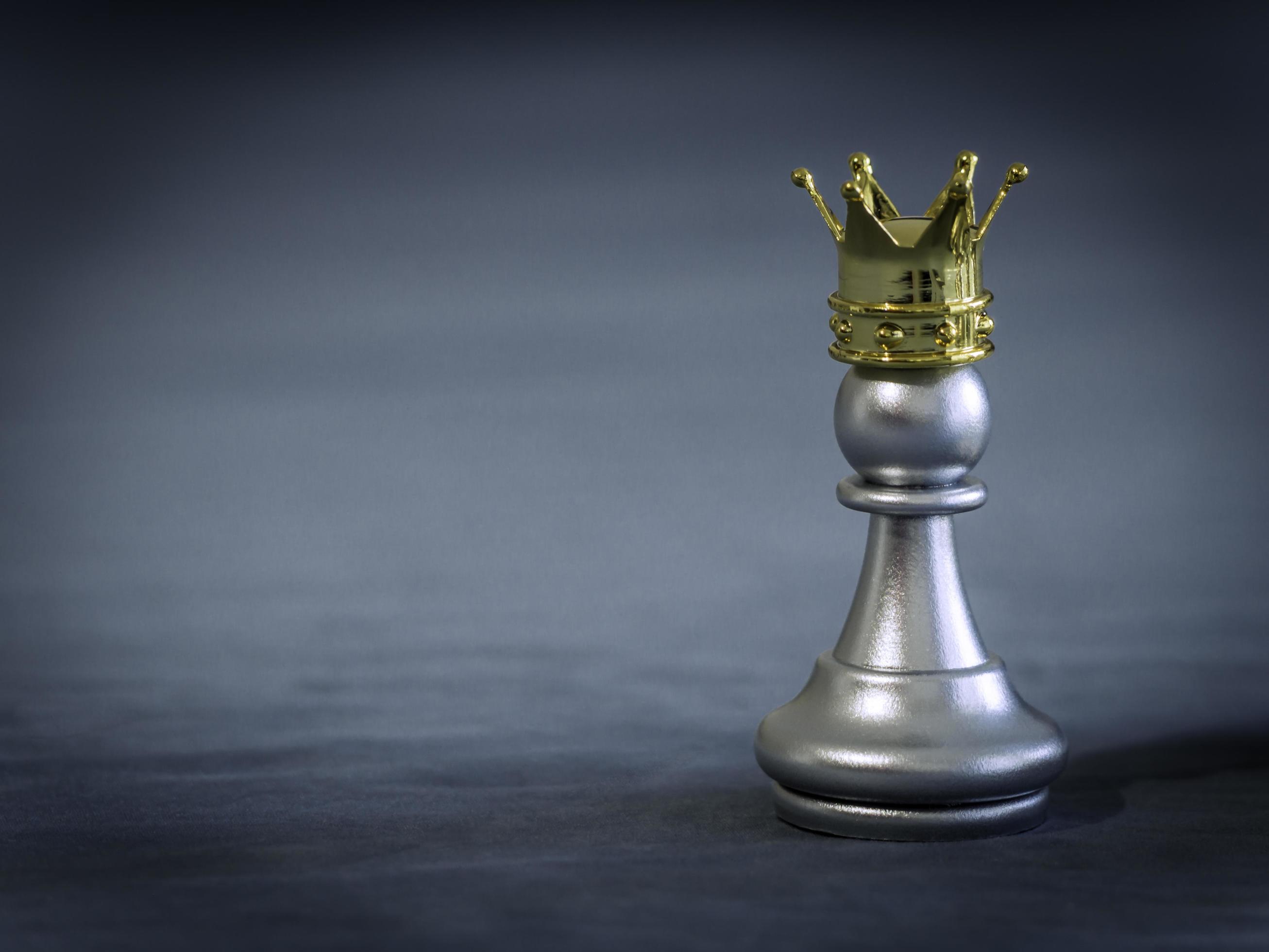 The gold horse, knight chess piece standing with falling silver pawn chess  pieces on chessboard on white background with copy space. Leadership,  winner, competition, and business strategy concept. Photos