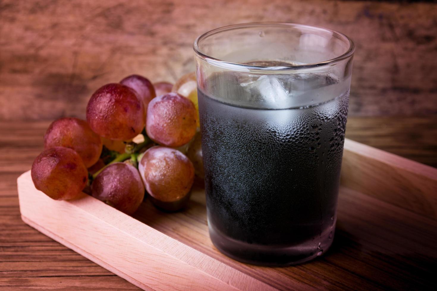 Fresh and juice grapes on wooden table photo