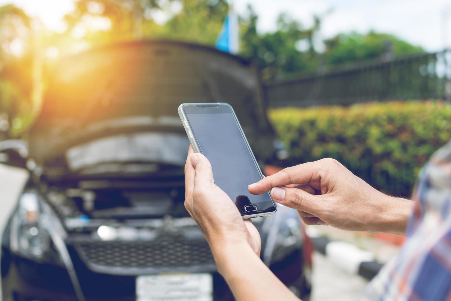 Man Phoning For Help with a broken down car photo