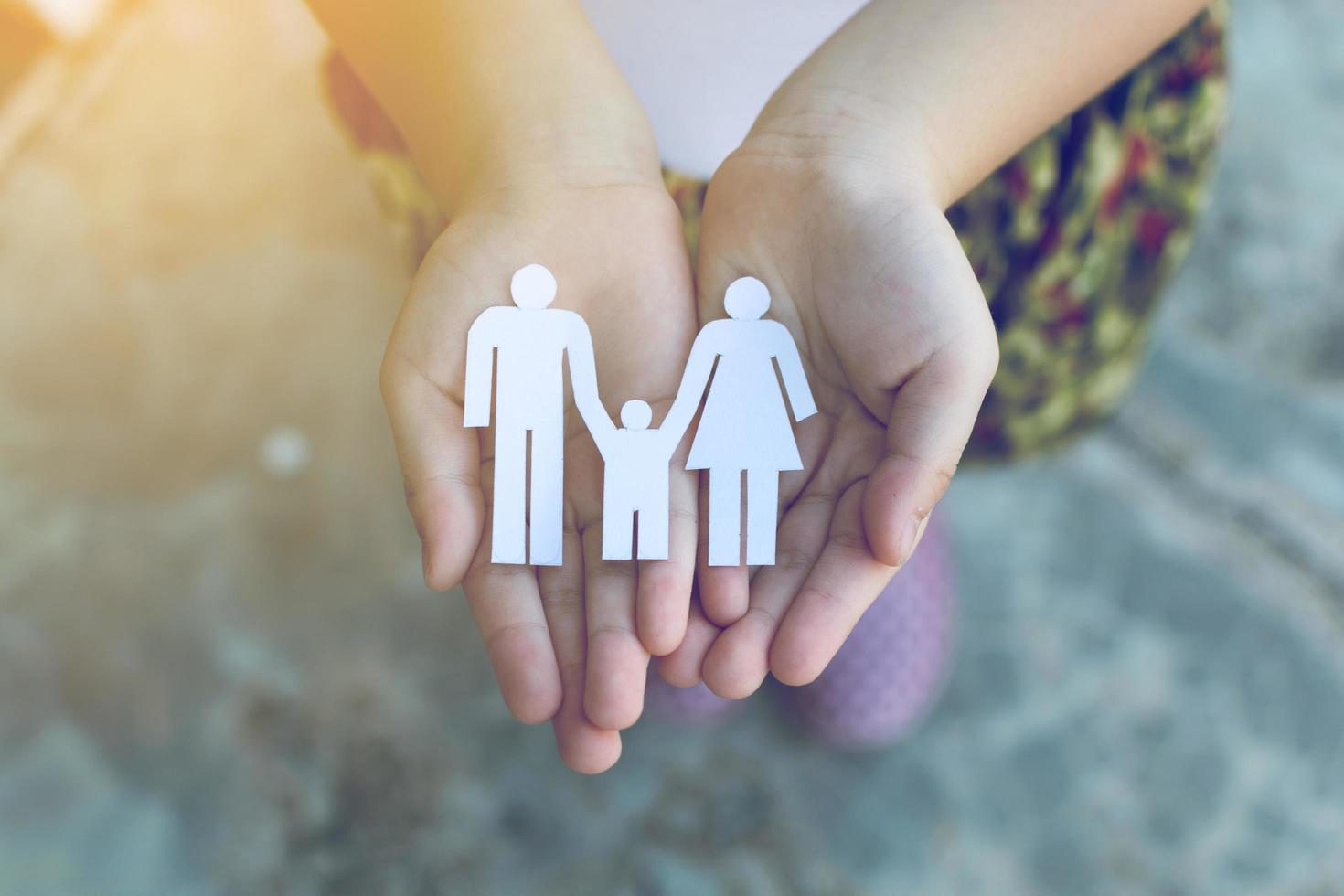 Children hands holding small model of heart and family , concept family photo