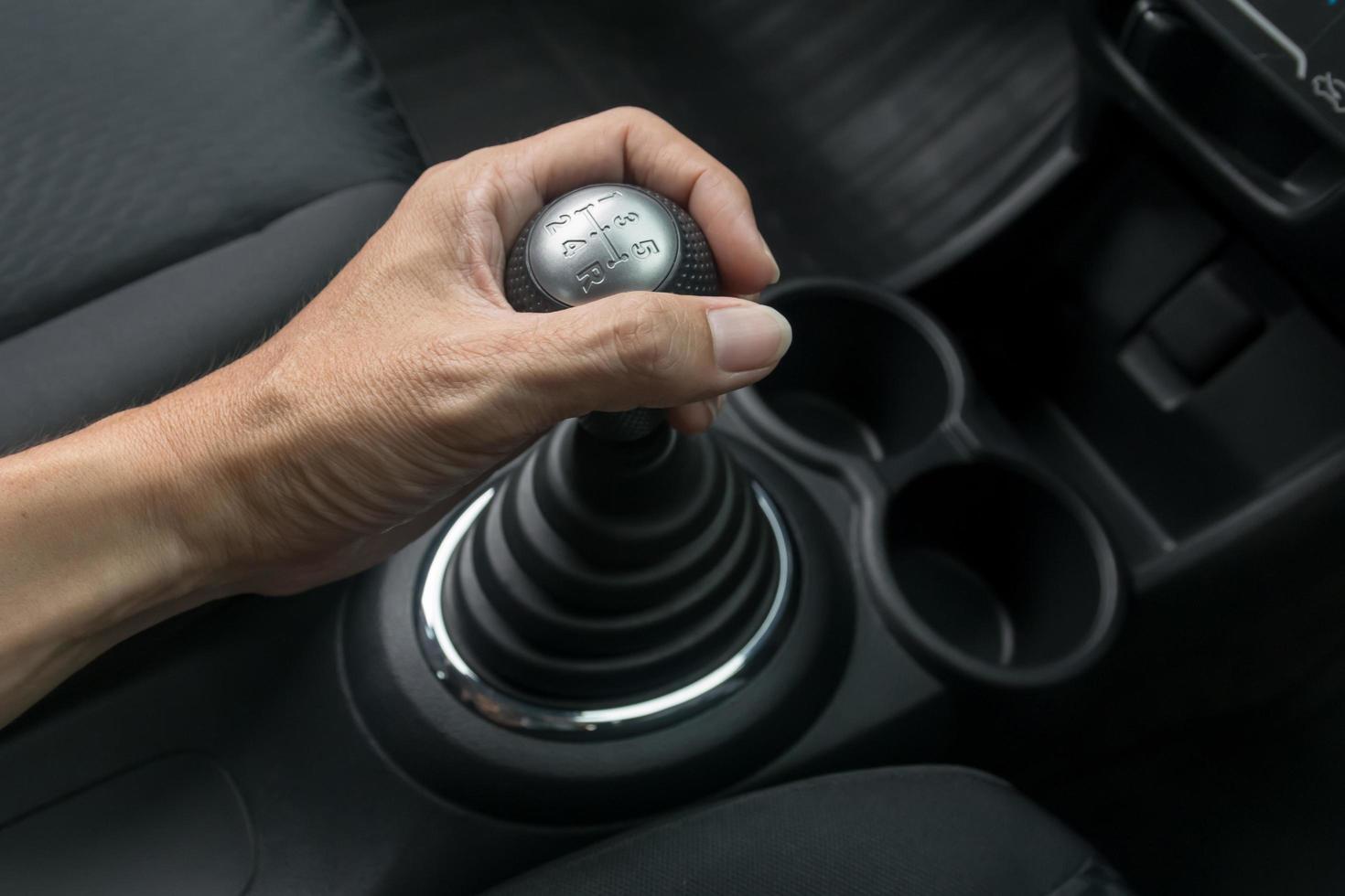 Man hand holding manual transmission photo