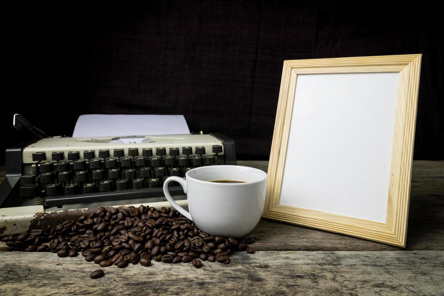 typewriter and coffee on wood background photo