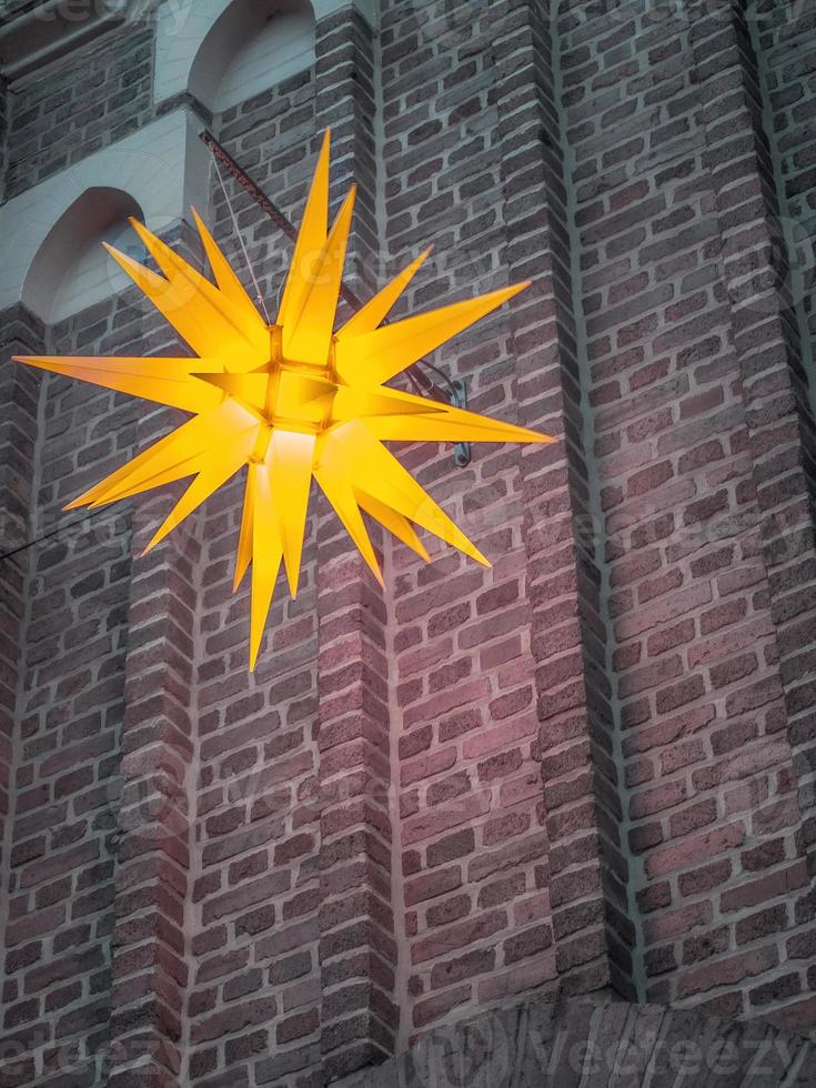 Scenic shot of a star shaped lamp hanging from a building photo