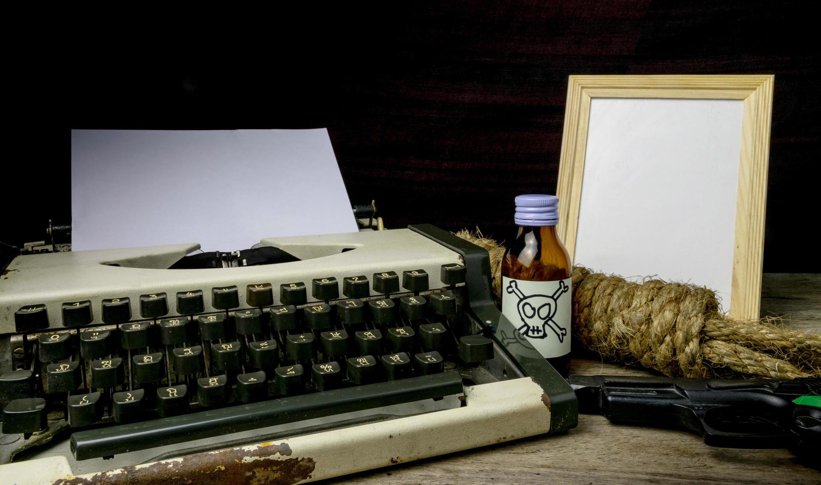 Typewriter with paper page and poison and gun. Concept writer Romance Suspense photo