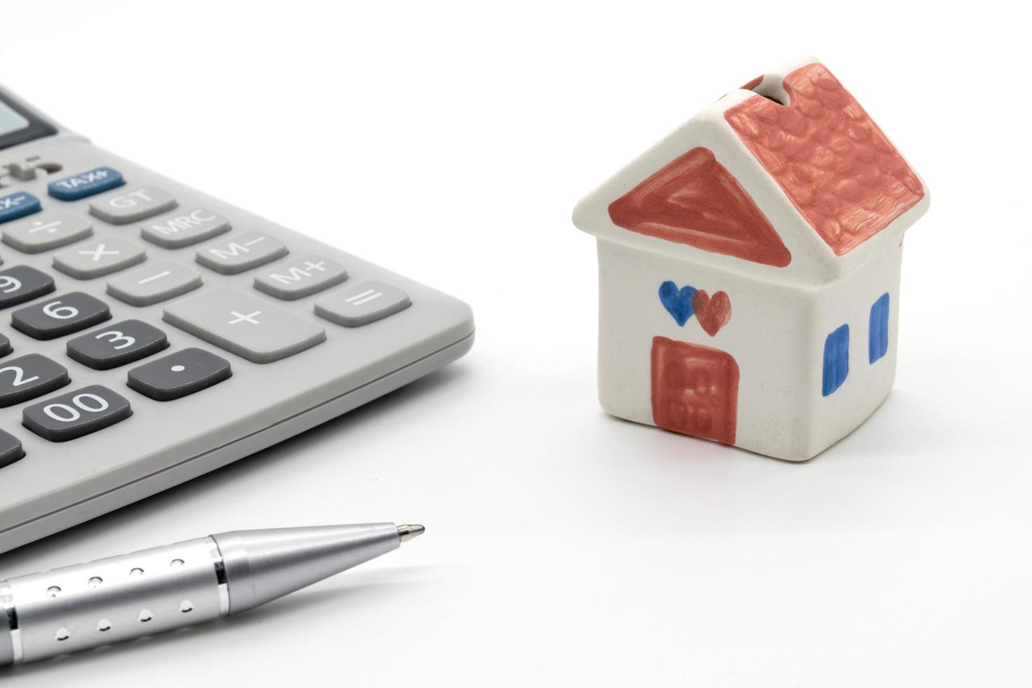 House and calculator on white background photo