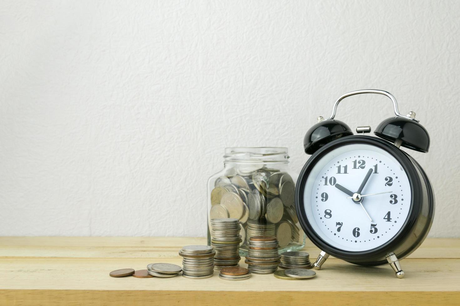 clock and stacks of coins for business money concept photo