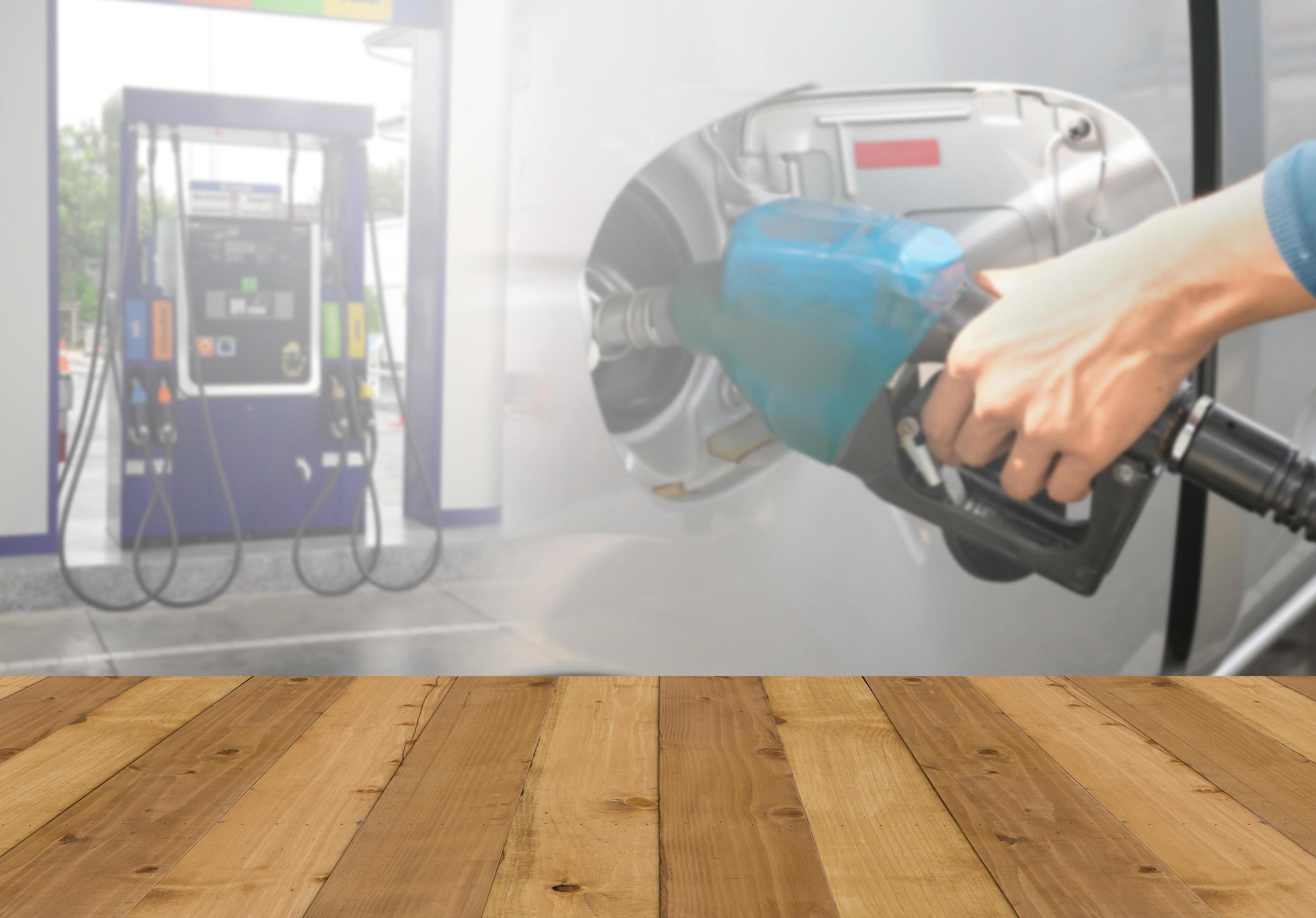 Wood floor and Hand holding Fuel nozzle pouring background 7133860
