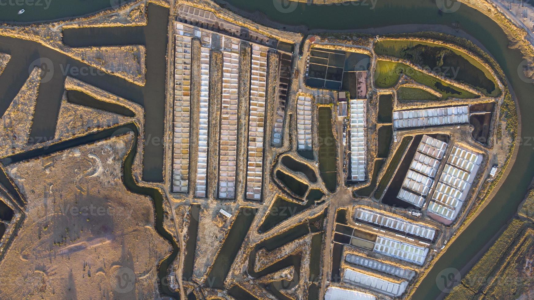 Aerial drone view of salt fields in Castro Marim, Portugal. Sunset cinematic shot. Nice vibrant colors. Salt extraction. photo