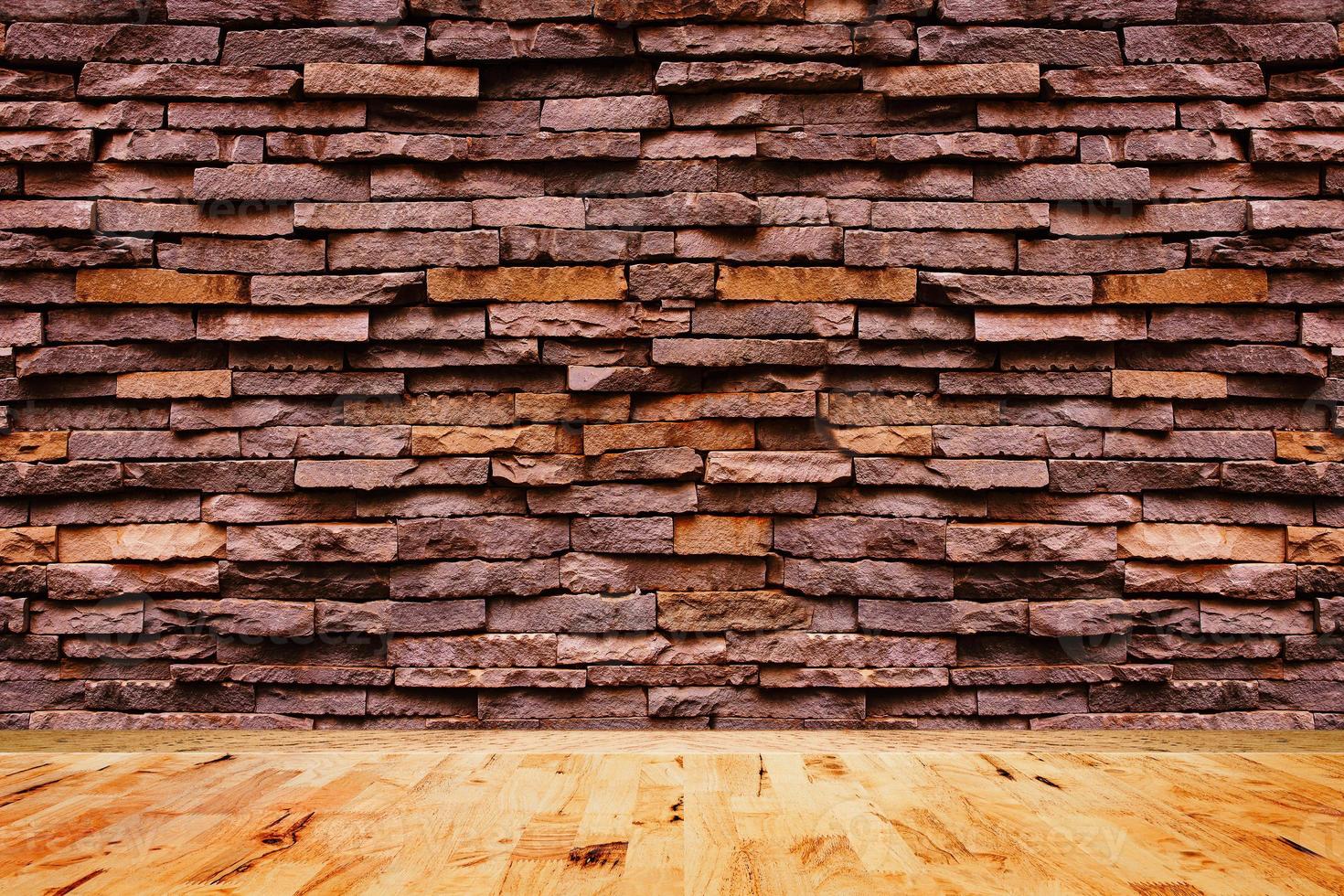 Empty wood floor texture with decorative stone wall background. photo
