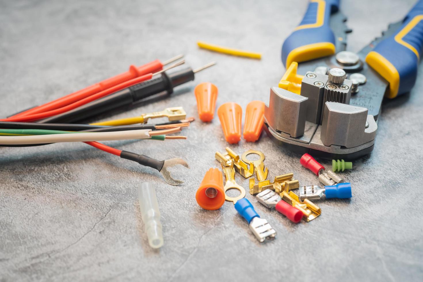 Wire strippers or cable strippers tool and Solderless Terminals on desk. Electrical tools concept ,selective focus photo