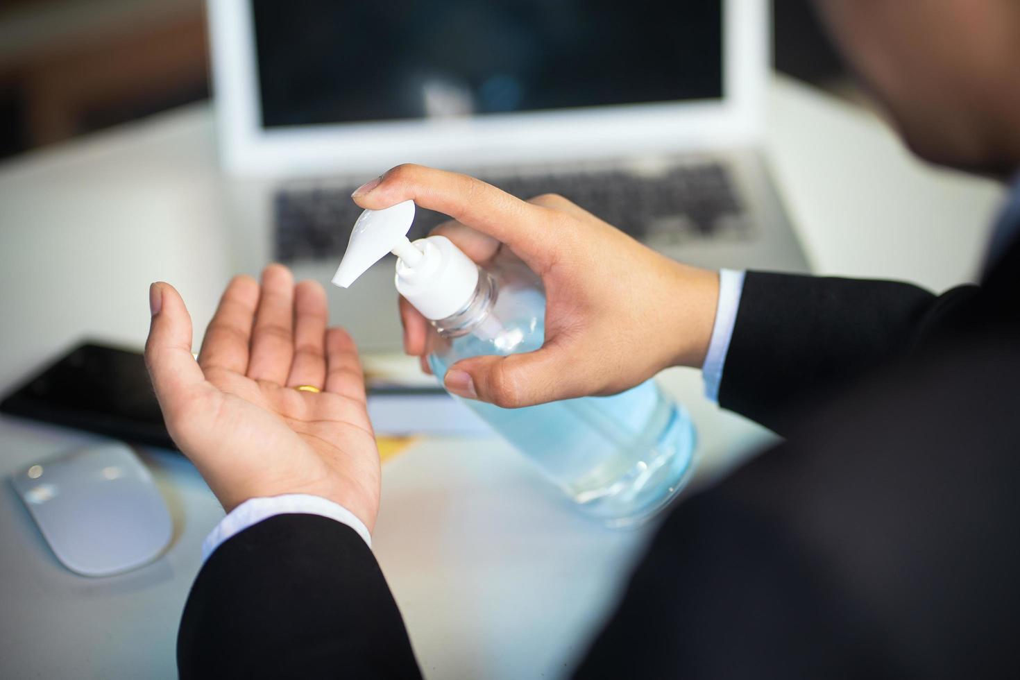 Business man washing hands with alcohol gel or antibacterial soap sanitizer  .Hygiene concept. prevent the spread of germs and bacteria and avoid infections corona virus photo