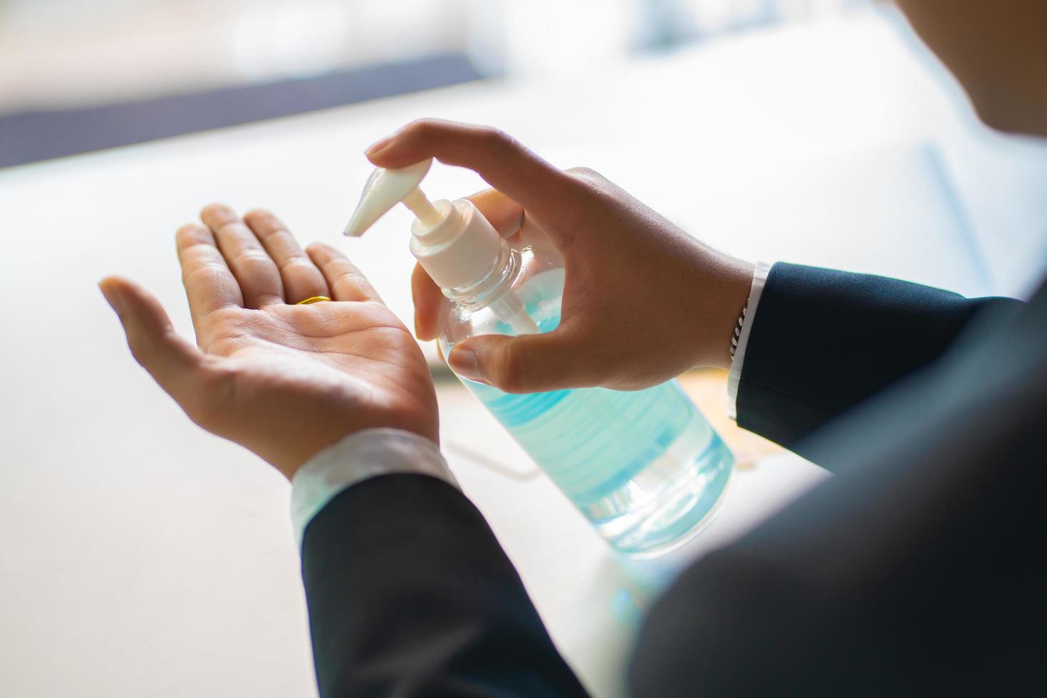 Business man washing hands with alcohol gel or antibacterial soap sanitizer  .Hygiene concept. prevent the spread of germs and bacteria and avoid infections corona virus photo