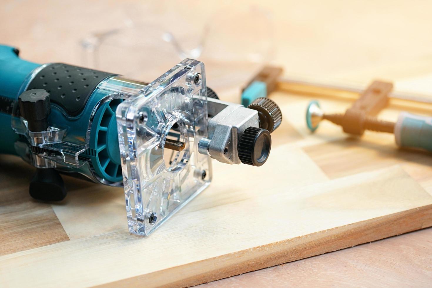 Electric Trimmer ,Wood Router Tools on Walnut Plywood in workshop, woodworking Handicraft and diy concept .selective focus photo