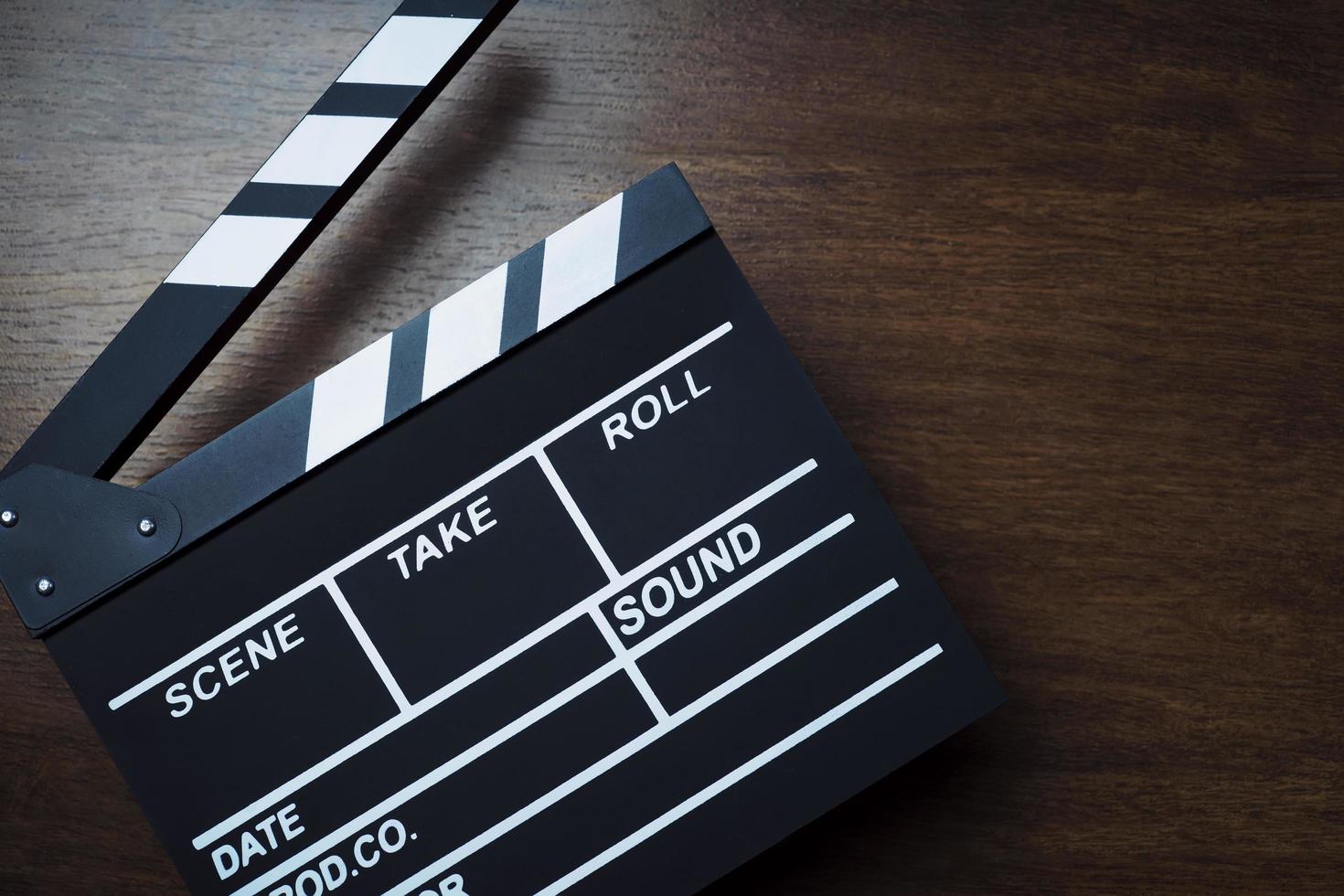 movie clapper cinema board or Slate film.Clapperboard for filmmaking and video production to assist in synchronizing of picture ,sound on Wooden Floor Tiles background.cinema concept photo