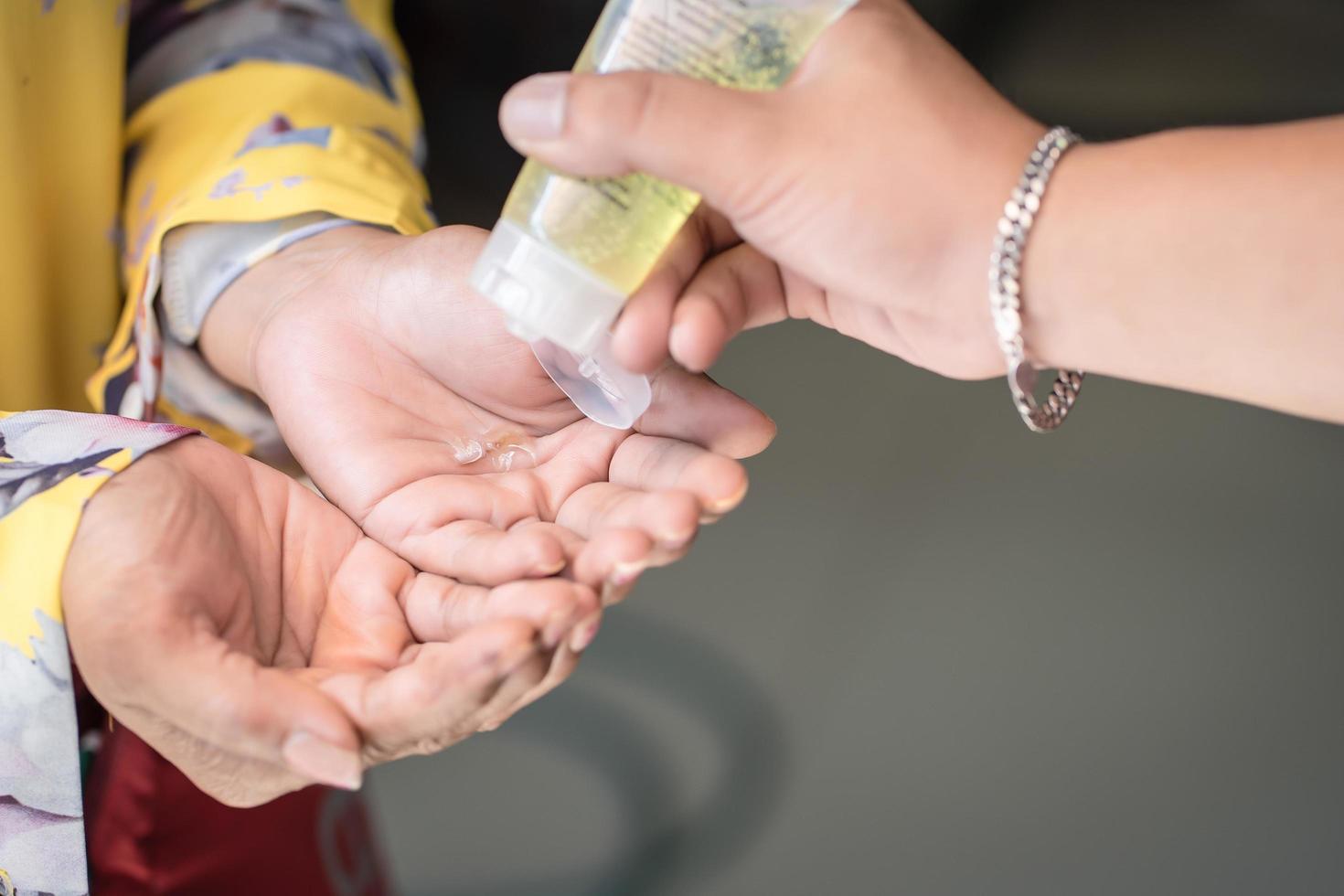 man using alcohol gel or antibacterial soap sanitizer on mother hand.Hygiene,Coronavirus concept.prevent the spread of germs and bacteria and avoid infections corona virus,covud19 virus photo