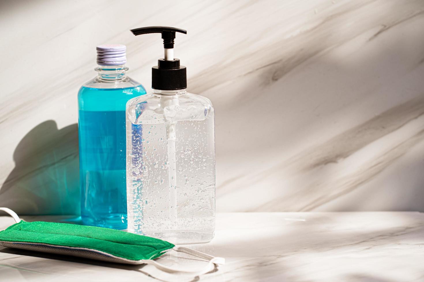 sanitizer gel with clear Plastic bottle pump and medical surgical masks .antiseptic hand gel or alcohol gel prevent the spread of germs and bacteria and avoid infections corona virus,covid19 photo