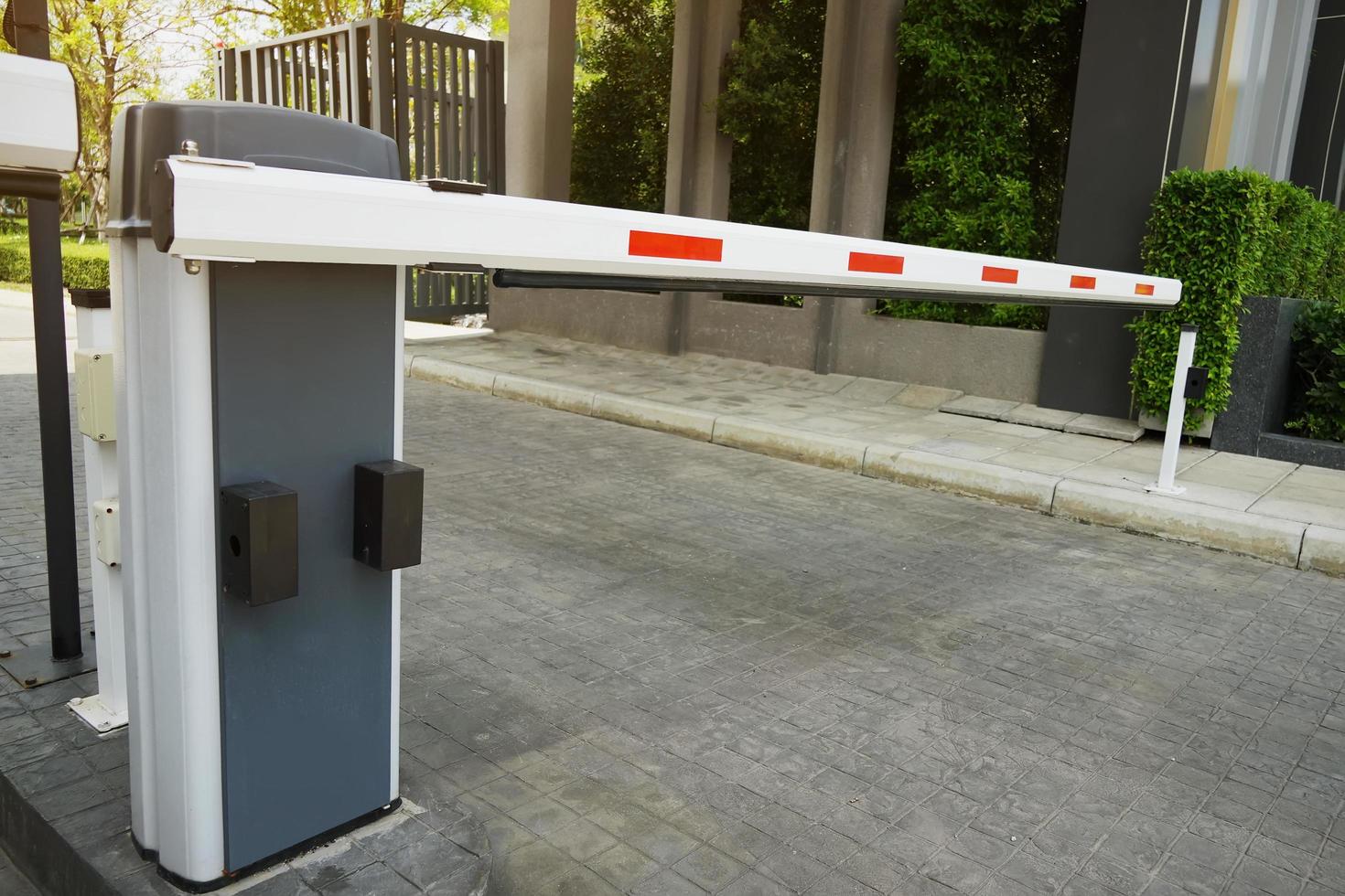 Automatic Barrier Gate , Security system for building and car entrance vehicle barrier of a beautiful and shady village photo