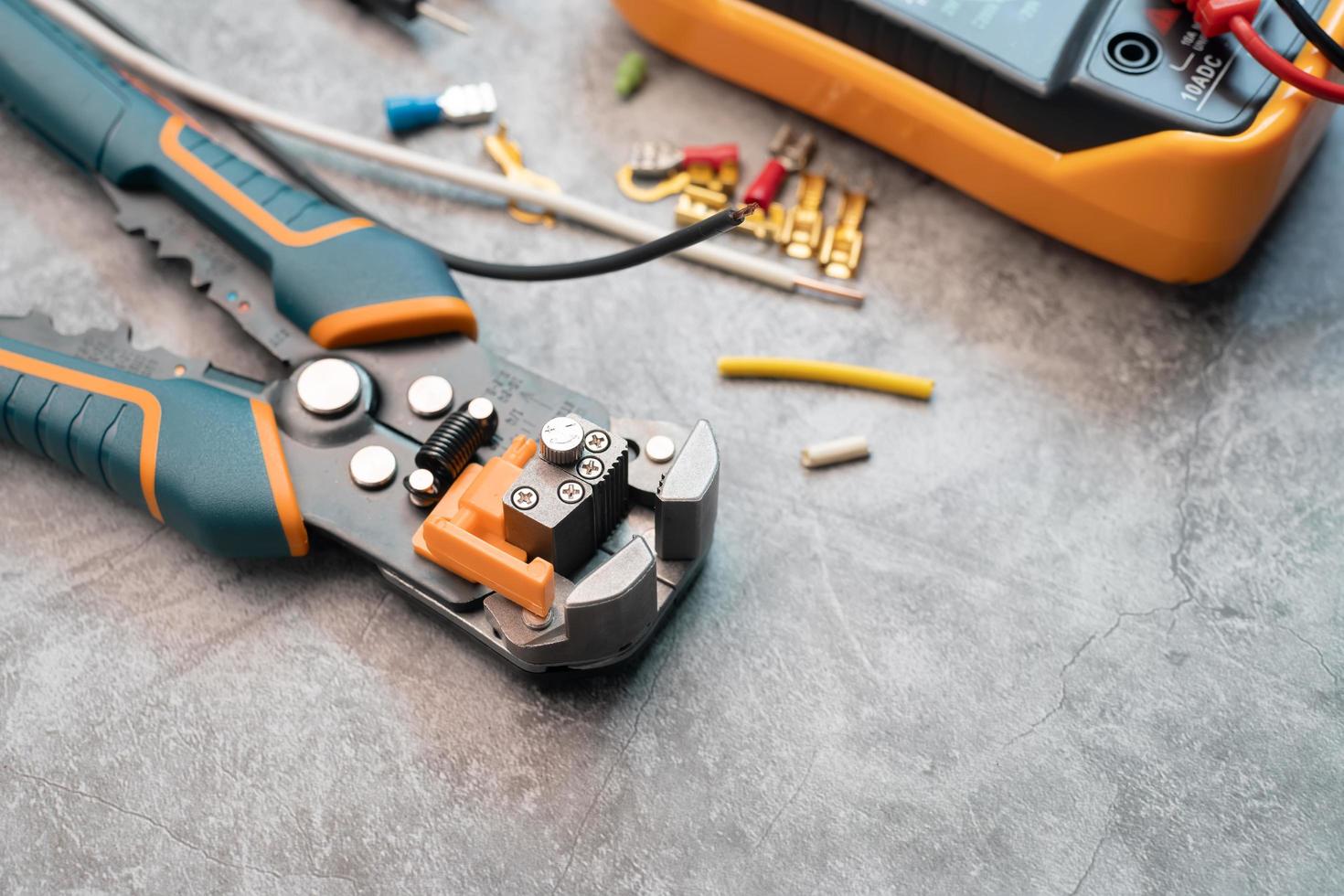 Wire strippers or cable strippers tool on desk. Electrical tools concept photo