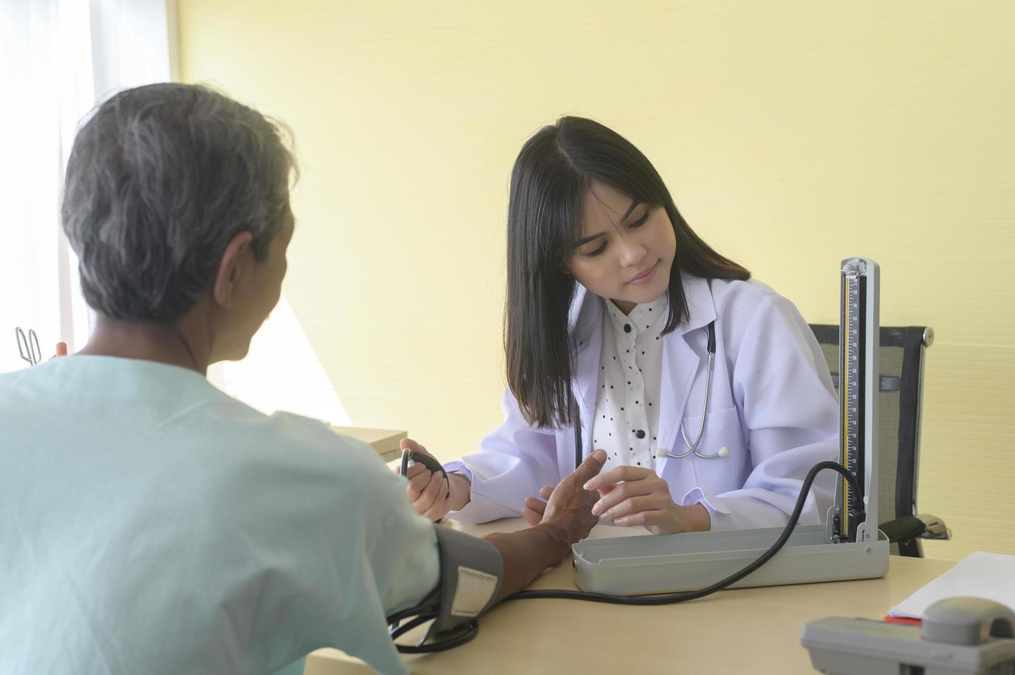 Asian senior male patient is consulting and visiting doctor in hospital.. photo