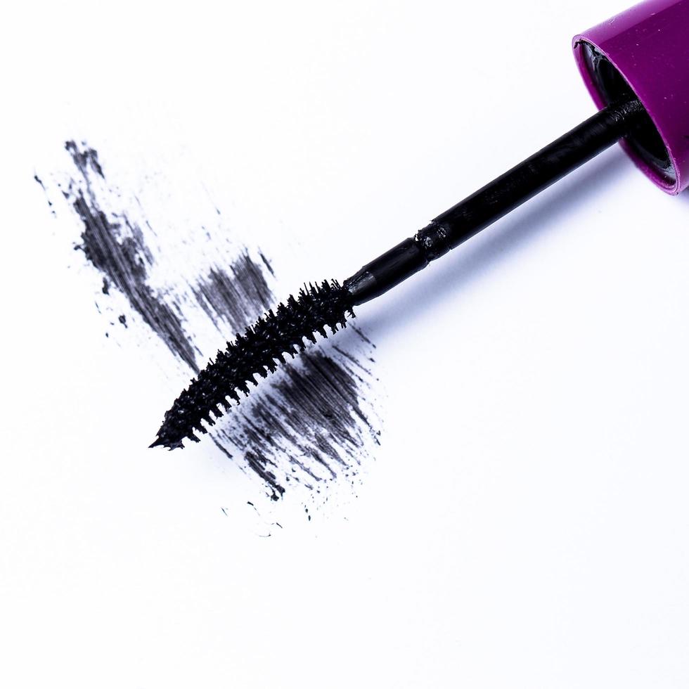 Mascara brush over white background photo