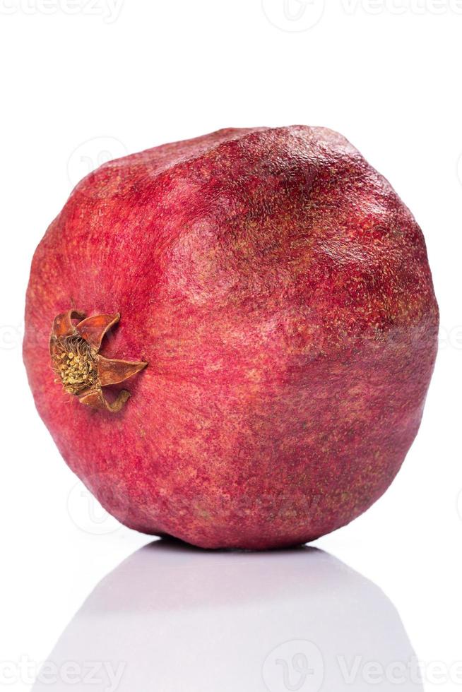 Whole pomegranate isolated on white photo