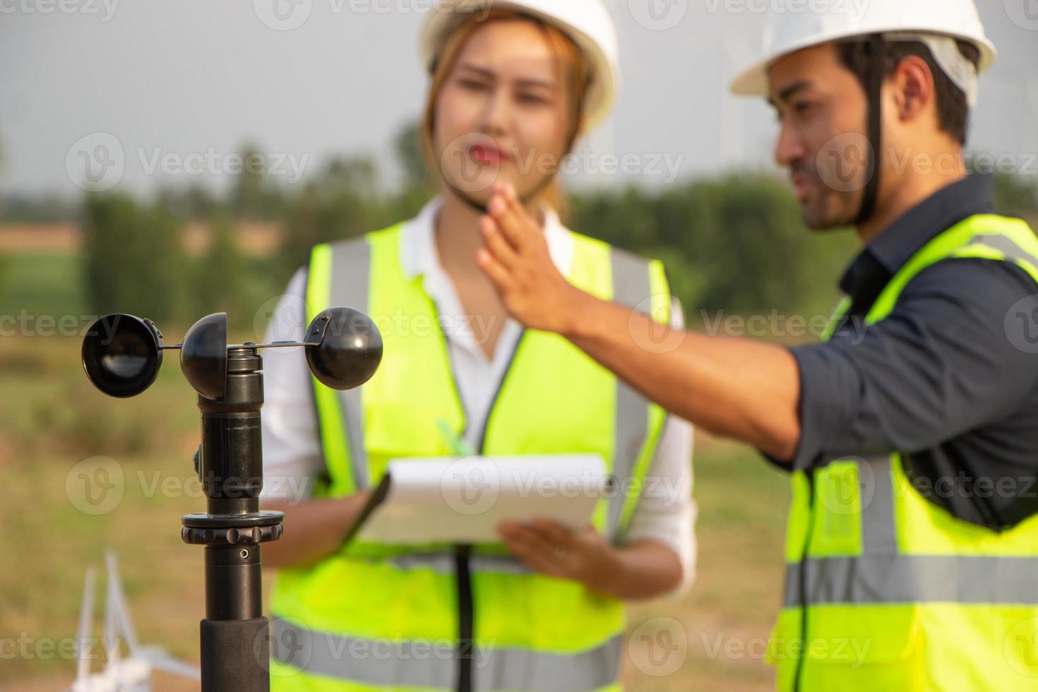 engineer team working in wind turbine farm. Renewable energy with wind generator by alternative energy concept. photo
