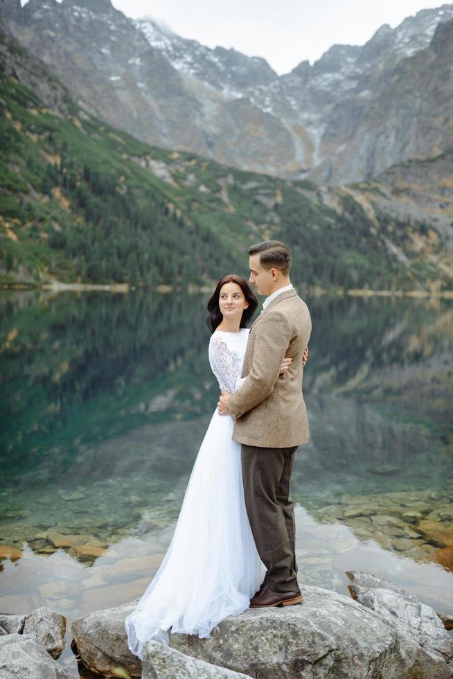 Loving couple on the background of the Sea-eye lake in Poland photo