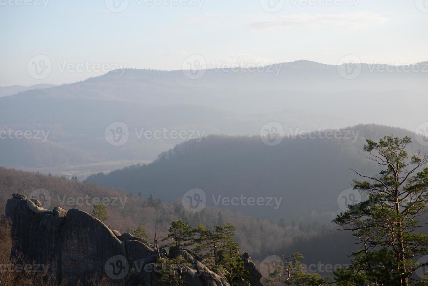 The bride and groom are standing on top of a cliff. Sunset. photo