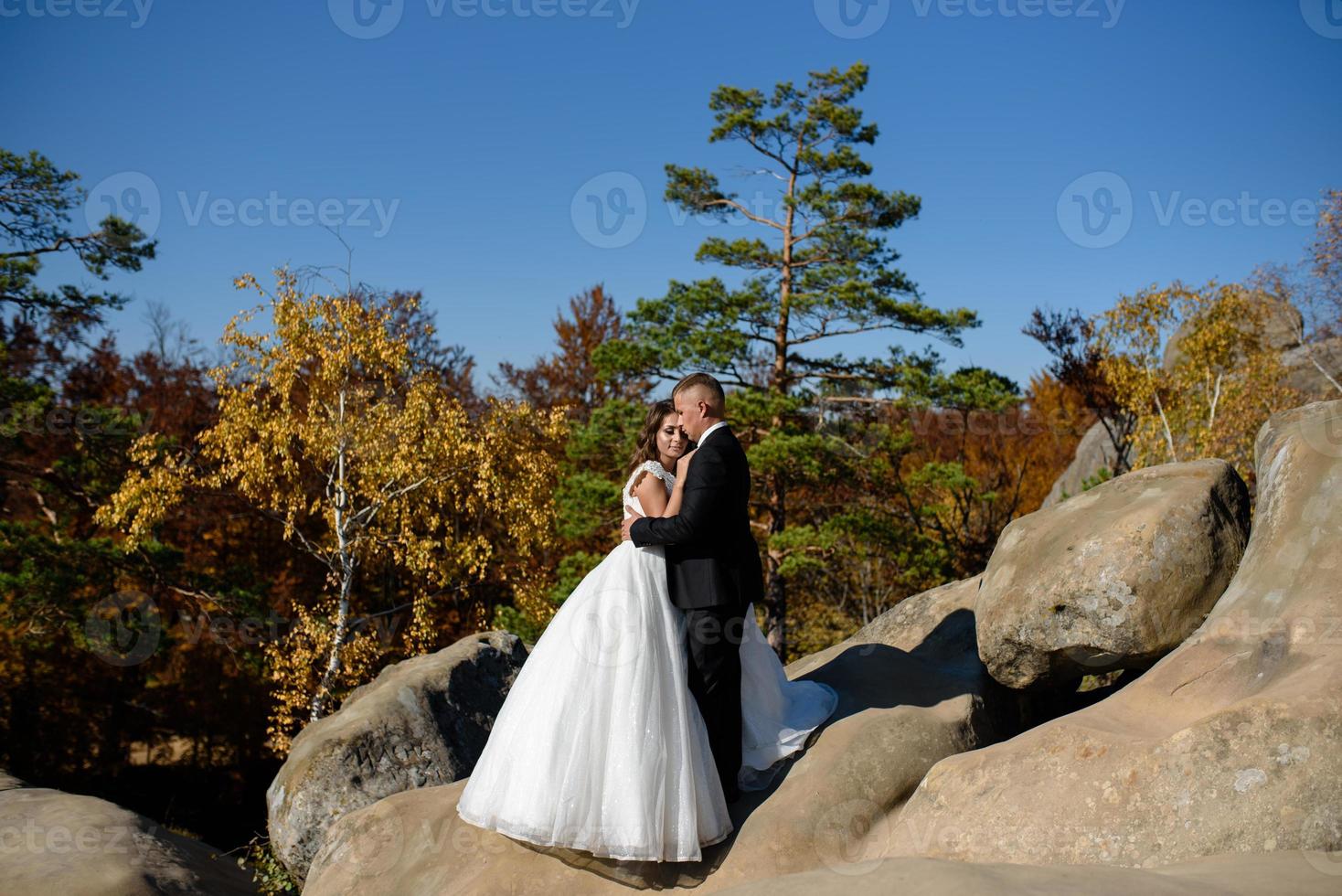 Bride and groom. A couple strolling among the narrow beautiful gorge. The gorge was overgrown with green moss. The newlyweds are spinning and running. photo