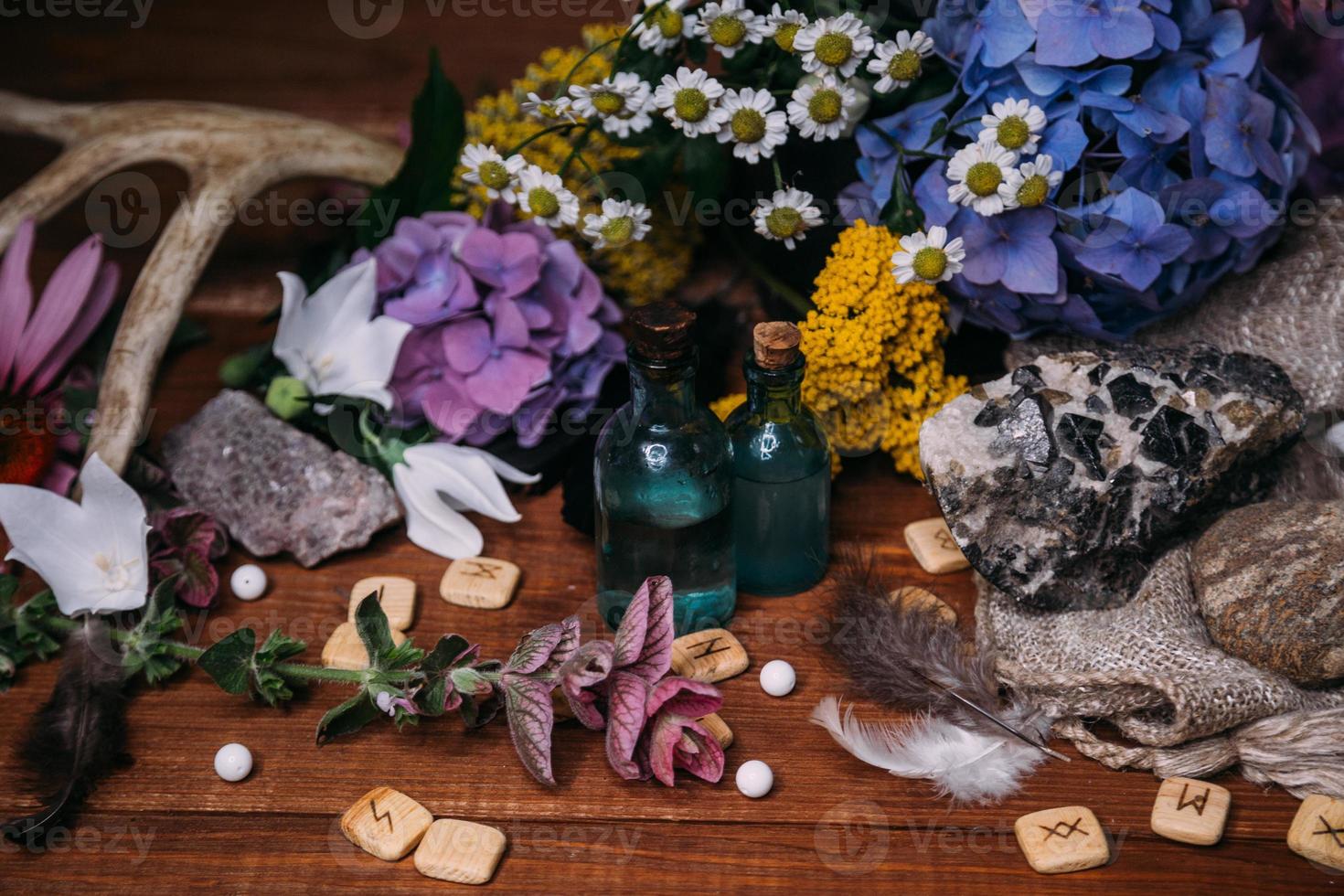 witchcraft concept with potions, herbs and occult equipment photo