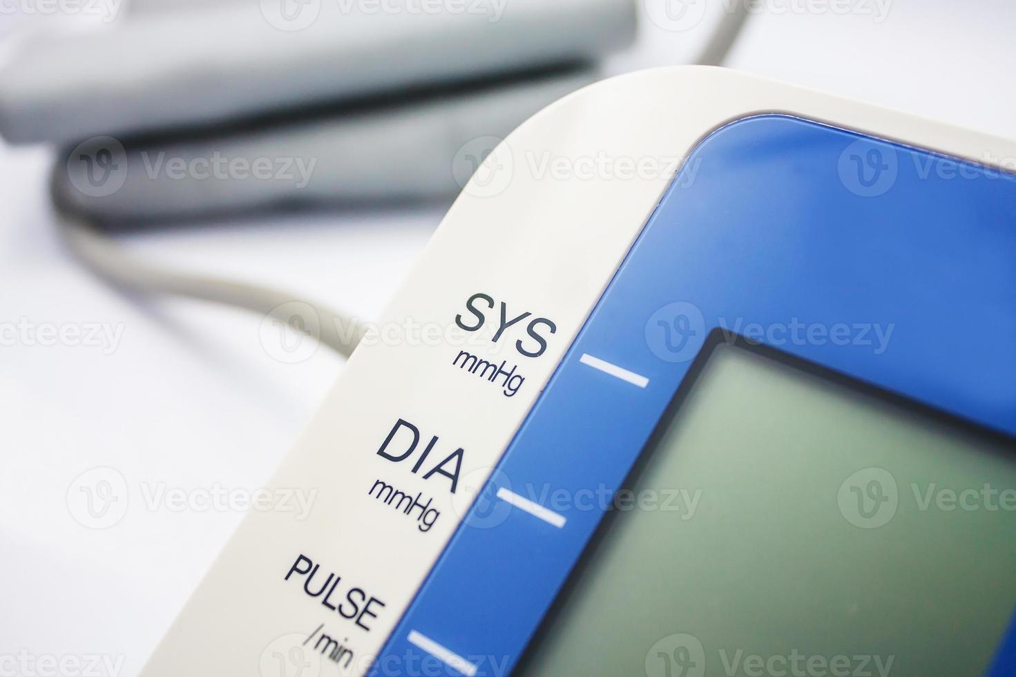 Digital Blood Pressure Monitor on white background photo