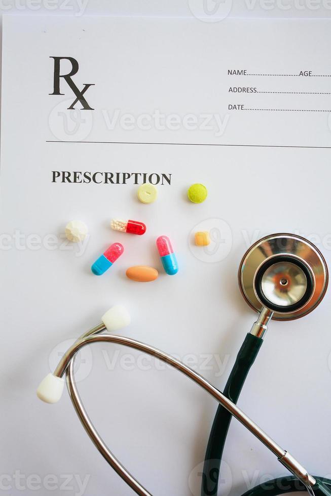 Pills and stethoscope on a prescription photo