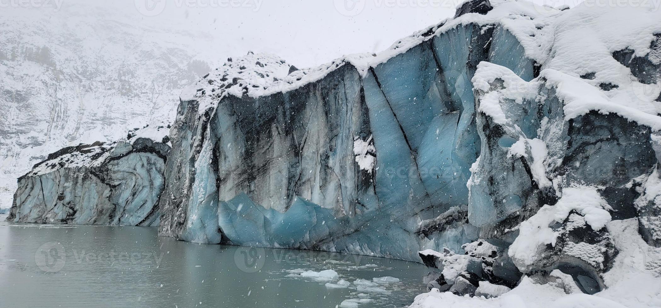 Alaskan glacier face on a lake photo