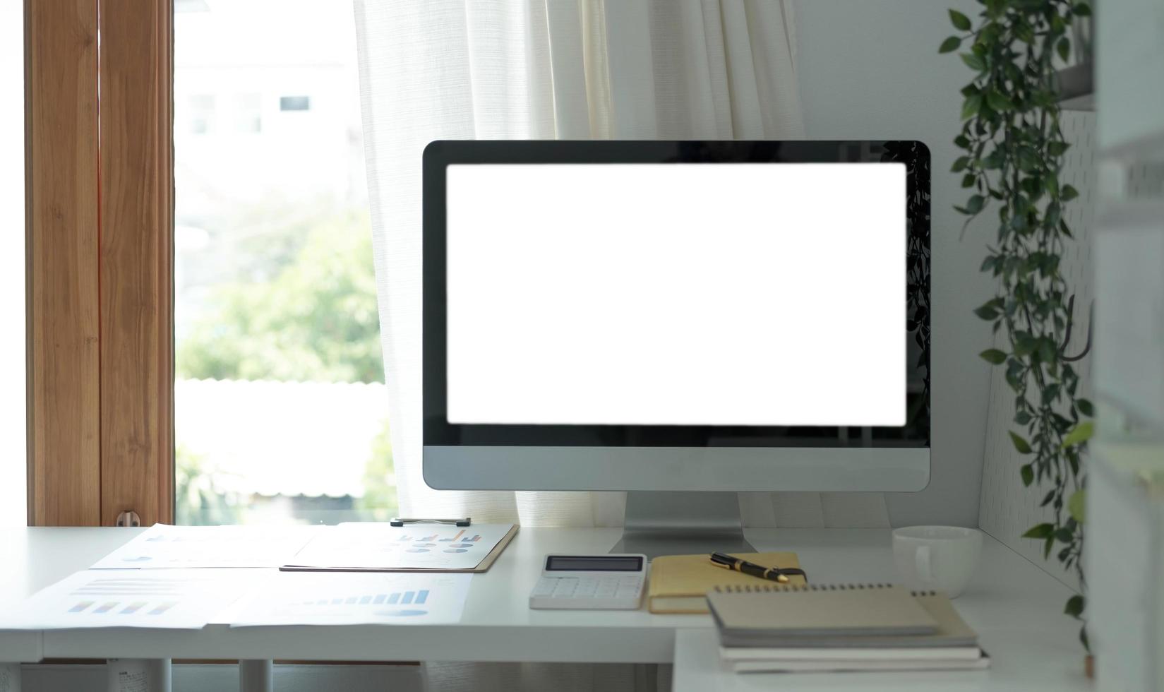 Blank screen desktop computer in minimal office room with decorations and copy space photo