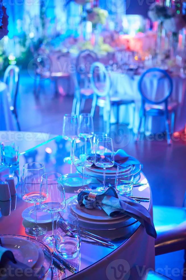 Table setup in purple light. Ready to event. Shallow dof photo