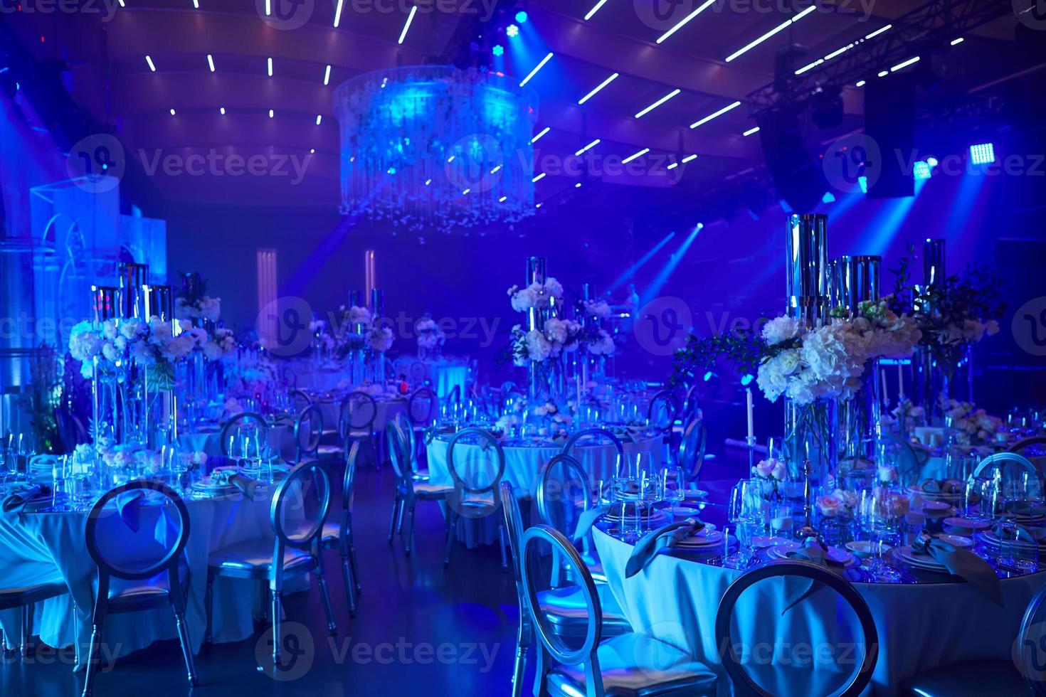 Table setup in blue light. Ready to event. photo