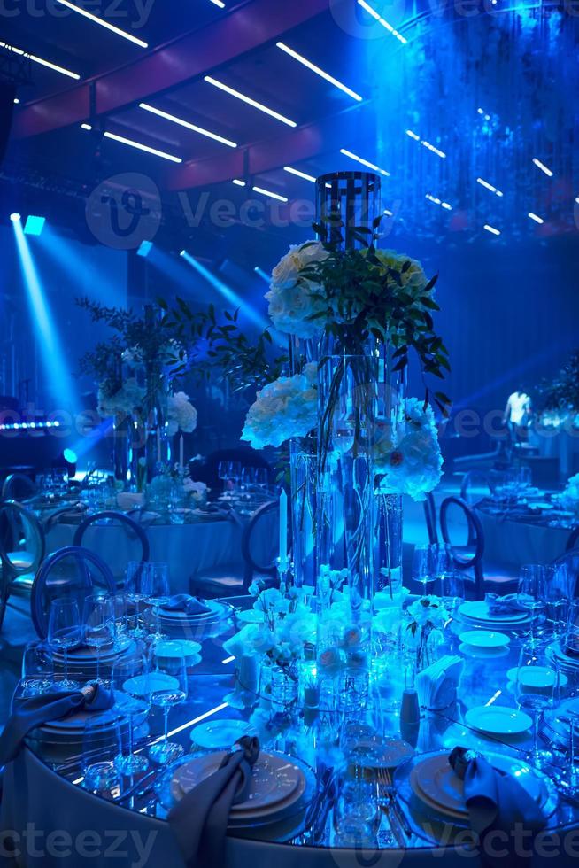 Table setup in blue light. Ready to event. photo