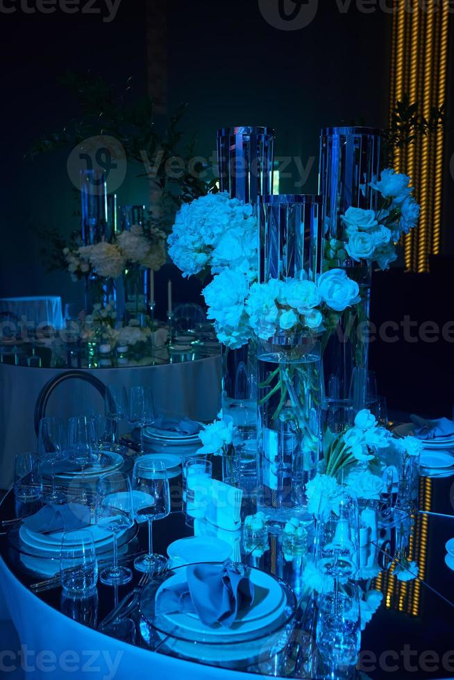 Table setup in blue light. Ready to event. photo