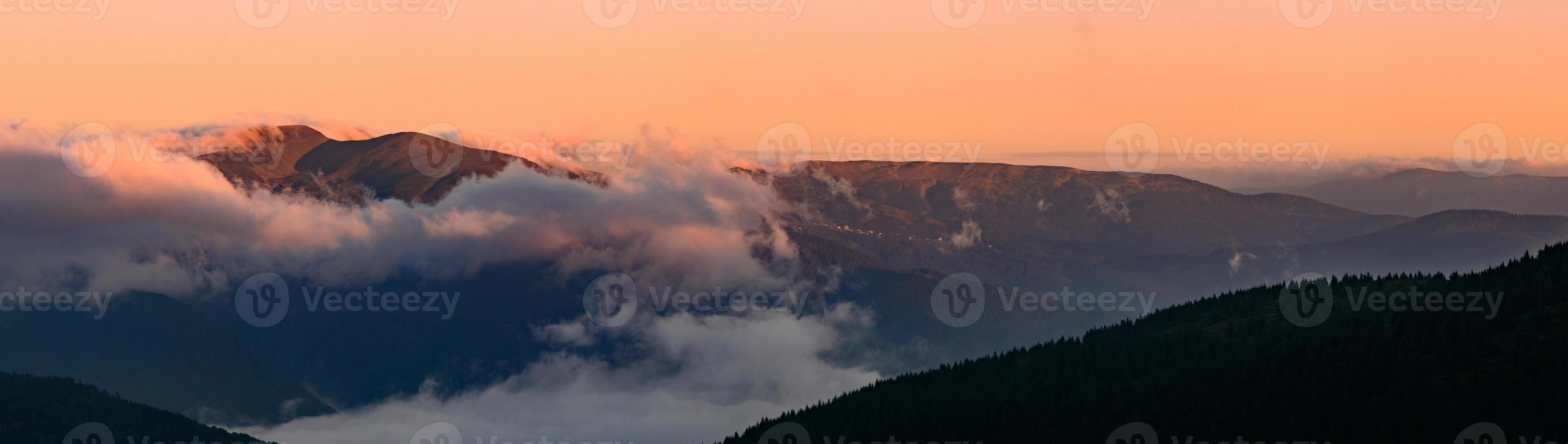 Petros Mountain in the morning fog, overcast mountain range at dawn, the magical mountains of Ukraine. photo