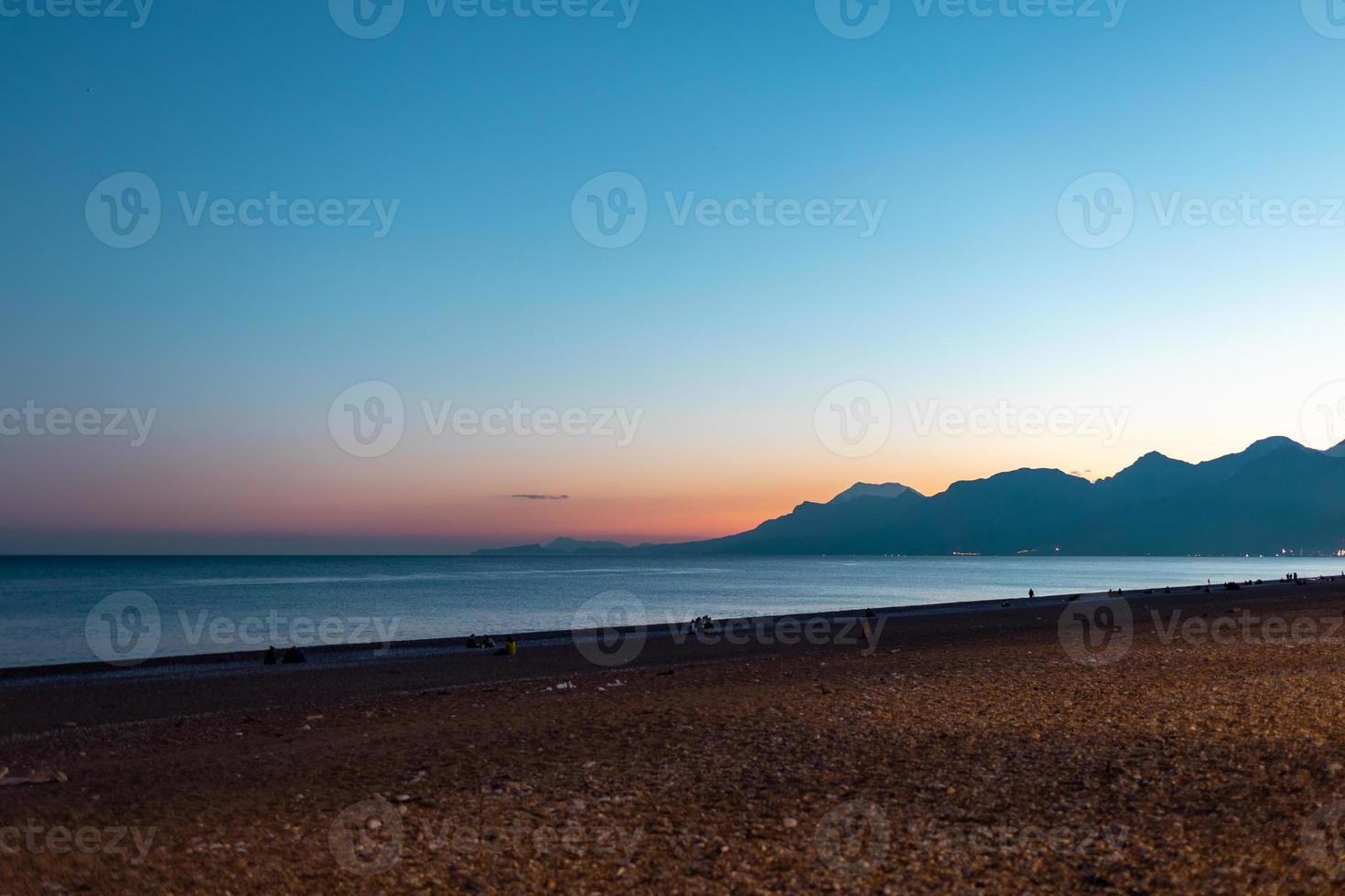 Sea and mountains at sunset, ocean waves photo