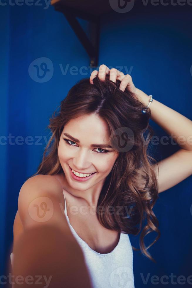 Pleasant girl making selfie in studio photo