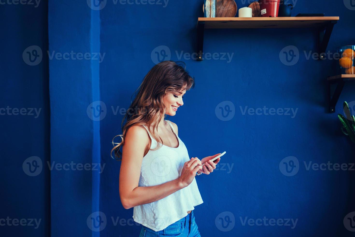 Attractive young woman looking at her smart phone photo