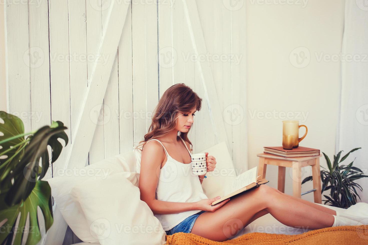 happy young woman with cup of coffee or tea photo