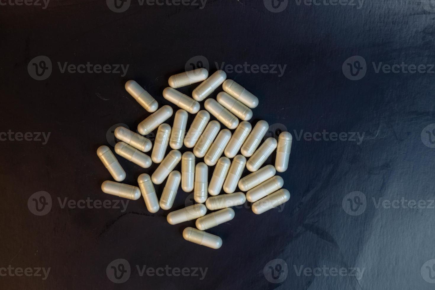 pills on black background photo