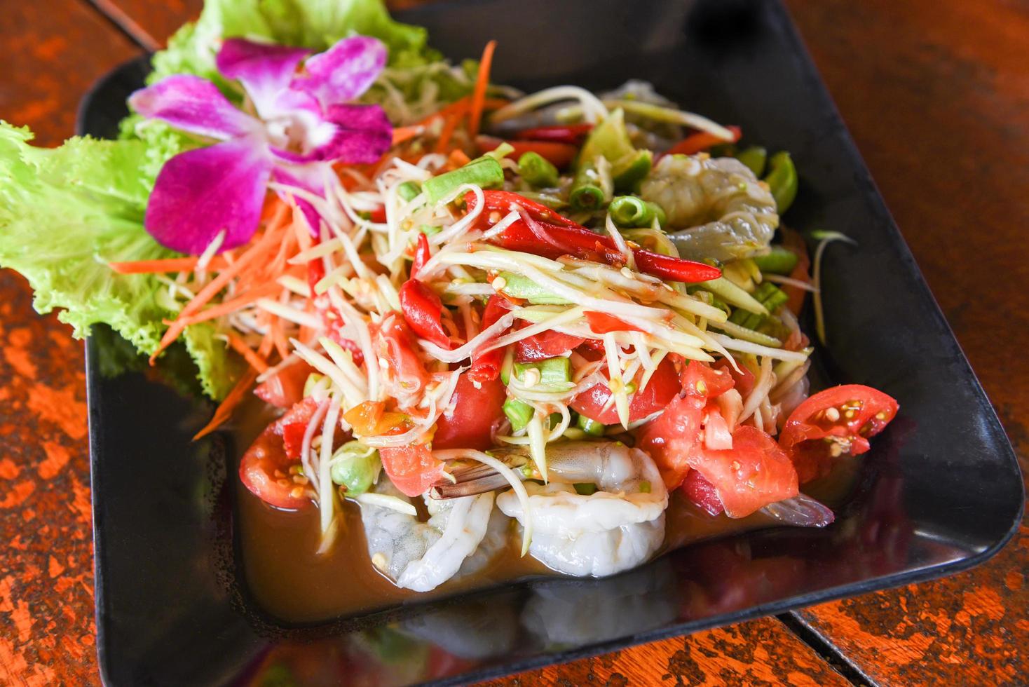 Green papaya salad with shrimp prawn Thai food, spicy salad herbs photo