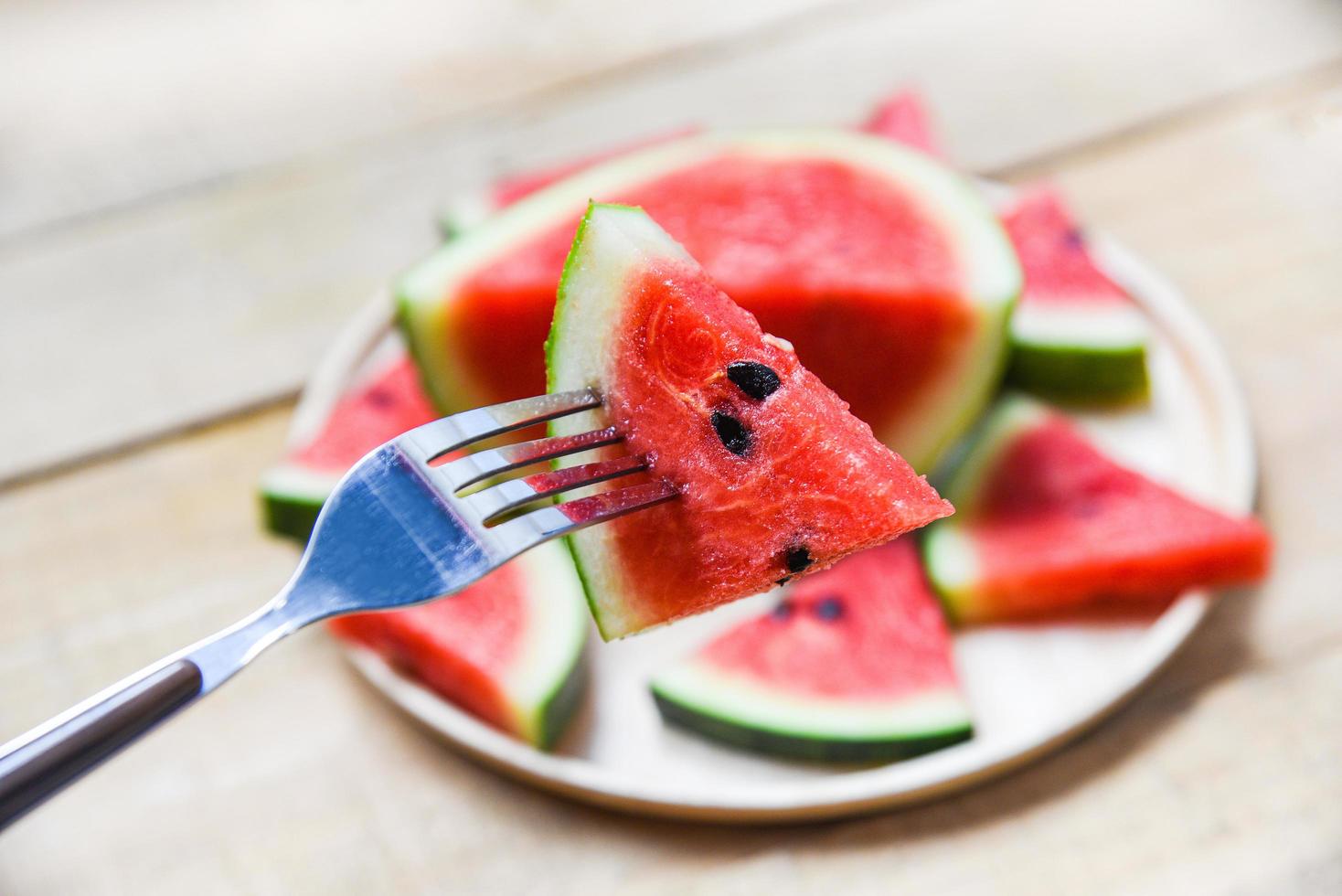 Fresh watermelon slice on wooden tray summer fruit - watermelon on fork photo