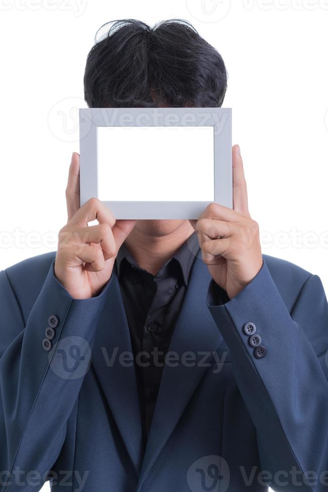 Asian businessman in a blue suit showed a blank photo frame in his hands.